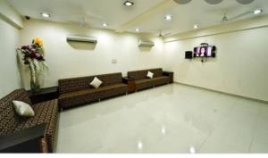 a room with couches and a tv in a room at Hotel Durga Silverline in Jodhpur