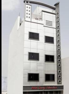 a tall white building with windows on the side of it at Hotel Durga Silverline in Jodhpur