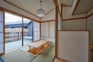 an empty room with a bench and a large window at Azumi Setoda in Onomichi
