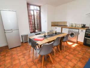 a kitchen with a table and chairs in a kitchen at Curlew Cottage in Carnforth