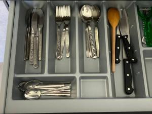 a drawer filled with utensils and spoons and forks at Sunset Studio Apartment in Poprad
