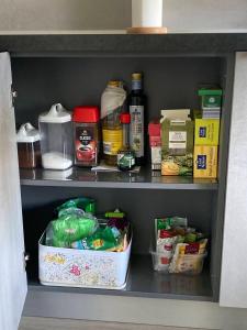 a cupboard filled with lots of food at Sunset Studio Apartment in Poprad