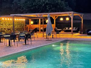 a swimming pool with tables and chairs and a pavilion at Prea Gianca in Bonifacio