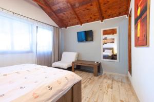 ein Schlafzimmer mit einem Bett und einem Stuhl in der Unterkunft Casa Ana in Vama Veche