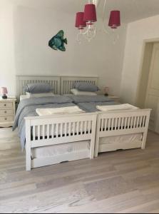 A bed or beds in a room at Spacious 2 storey apartment old town Mali Lošinj