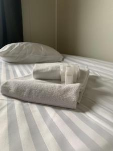 two towels sitting on top of a bed at Kiruna City Room in Kiruna