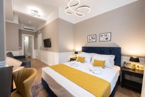 a bedroom with a large bed and a living room at Pure Hotel by Athens Prime Hotels in Athens