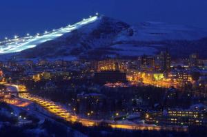a view of a city at night with a mountain at Kiruna City Room in Kiruna