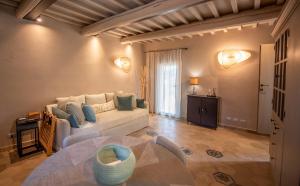 a living room with a couch and a table at Il Molino Carlotta House in Porto Ercole