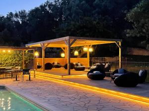 a patio with a pavilion and a pool at night at Prea Gianca in Bonifacio
