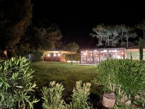 a house with lights in a yard at night at Prea Gianca in Bonifacio