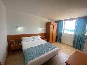 a hotel room with a bed and a window at Bahía Serena in Roquetas de Mar