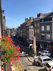 a view of a city street with cars and buildings at Appartement Erik Satie in Honfleur