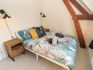 a bedroom with a bed and a night stand at 3 Mount Pleasant in Pershore