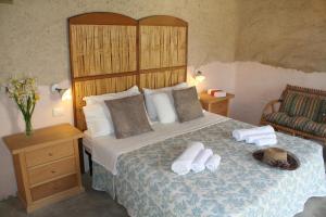 a bedroom with a bed with two towels on it at Il Canto di Kokopelli Country Houses in Brattirò