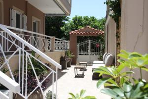 a patio with a white gate and some plants at Asteri Apartments Mytikas 2-Bedroom Seaview Courtyard in Mitika