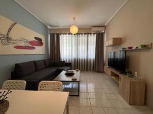 a living room with a couch and a table at City House 2 in Kalamata