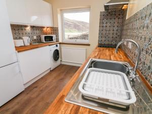 a kitchen with a sink and a dishwasher at Keartons - Buttertubs in Richmond