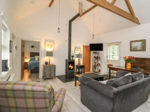 a living room with two couches and a fireplace at Willow Cottage in Aberystwyth