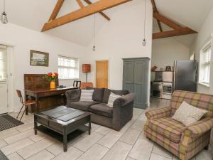 a living room with a couch and a table at Willow Cottage in Aberystwyth