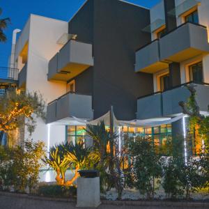 a building with a lot of windows in front of it at Tuo Hotel in Polignano a Mare