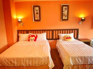 Ένα ή περισσότερα κρεβάτια σε δωμάτιο στο Wonderful Kenting Hostel