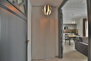 a hallway with a door leading to a dining room at Centre Historique -FREE Parking-WIFI-NETFLIX-ZEN&COSY-SLEEPNTRIPBEZIERS in Béziers