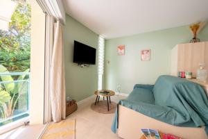 a living room with a couch and a window at Novaä in Antibes +4 photos