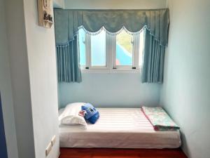 Ένα ή περισσότερα κρεβάτια σε δωμάτιο στο Wonderful Kenting Hostel