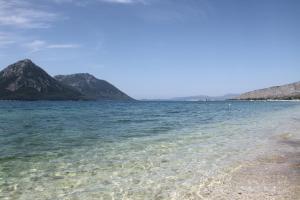 a view of the ocean with mountains in the background at Asteri Apartments Mytikas 2-Bedroom Seaview Courtyard in Mitika