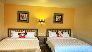 Ένα ή περισσότερα κρεβάτια σε δωμάτιο στο Wonderful Kenting Hostel