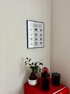 a plant sitting on top of a red table at Padova Dream: flat in the heart of Padua in Padova