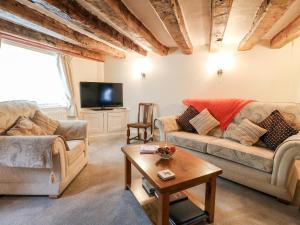 a living room with two couches and a tv at Hobson's Cottage 10 Main Street in Ilkeston