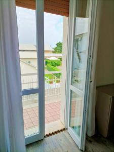 a sliding glass door with a view of a courtyard at Affitta Camere Elena in Colà di Lazise