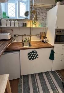 a small kitchen with white cabinets and a sink at Lovely 1-bedroom studio in the heart of Old Part of Termini Imerese in Termini Imerese