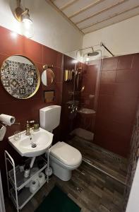 a bathroom with a toilet and a sink and a shower at Lovely 1-bedroom studio in the heart of Old Part of Termini Imerese in Termini Imerese