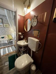 a bathroom with a toilet and a sink at Lovely 1-bedroom studio in the heart of Old Part of Termini Imerese in Termini Imerese