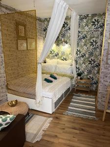 a bedroom with a bed with curtains and a rug at Lovely 1-bedroom studio in the heart of Old Part of Termini Imerese in Termini Imerese