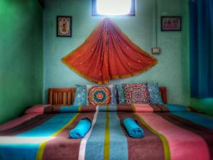 a bedroom with a large bed with a red canopy at Sharda Stay's Binsar Himalayas in Almora