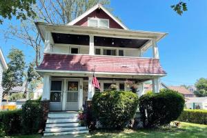 a house with an american flag in front of it at Grandma's Attic in Lakewood