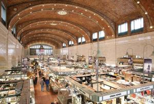a large building with people walking around in a market at Grandma's Attic in Lakewood