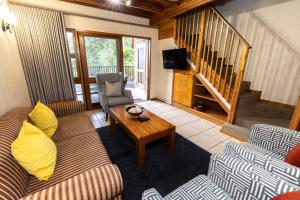 a living room with a couch and a table at Legend Safaris 257A - in Kruger Park Lodge in Hazyview