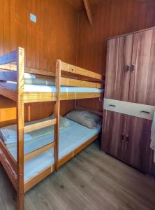 a bunk bed room with two bunk beds in a cabin at Rózsapark Panoráma-apartman - maximum 4 fő részére in Demjén