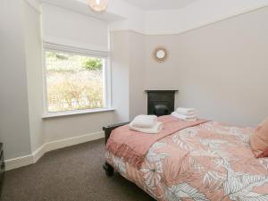 En eller flere senge i et værelse på Yewbarrow Cottage