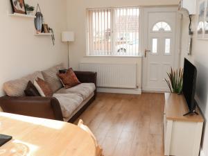 a living room with a couch and a table at Copse View in Lincoln