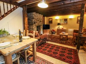 a living room with a table and a fireplace at Stable Cottage in Barnard Castle