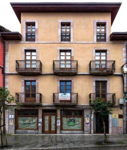 a building with balconies on the side of it at Apartamentos Los Molinos in Llanes