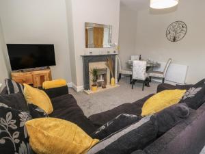 a living room with a couch and a fireplace at Calder Cottage in Sowerby Bridge
