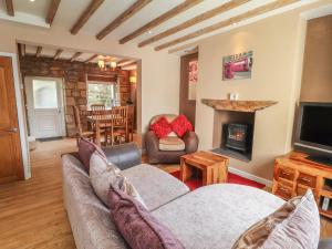 a living room with a couch and a fireplace at 27 Green Road in Wrexham
