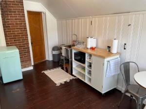 a kitchen with a counter and a table with chairs at Grandma's Attic in Lakewood